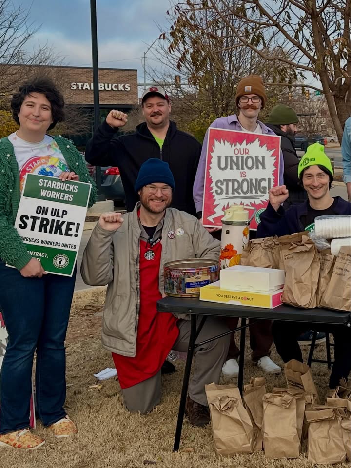 May be an image of ‎standing, park and ‎text that says '‎STAI STAIBUCKS BUCKS 生者 OUR UNION STRONG! IS הת! STARG STARBUCKS WORKERS STRIKE! ARBUCKS ORKERS UNITED ON ULP NTRACT, / YOUBESERNIEADSINLT YOU DUDESERVE DENUT‎'‎‎