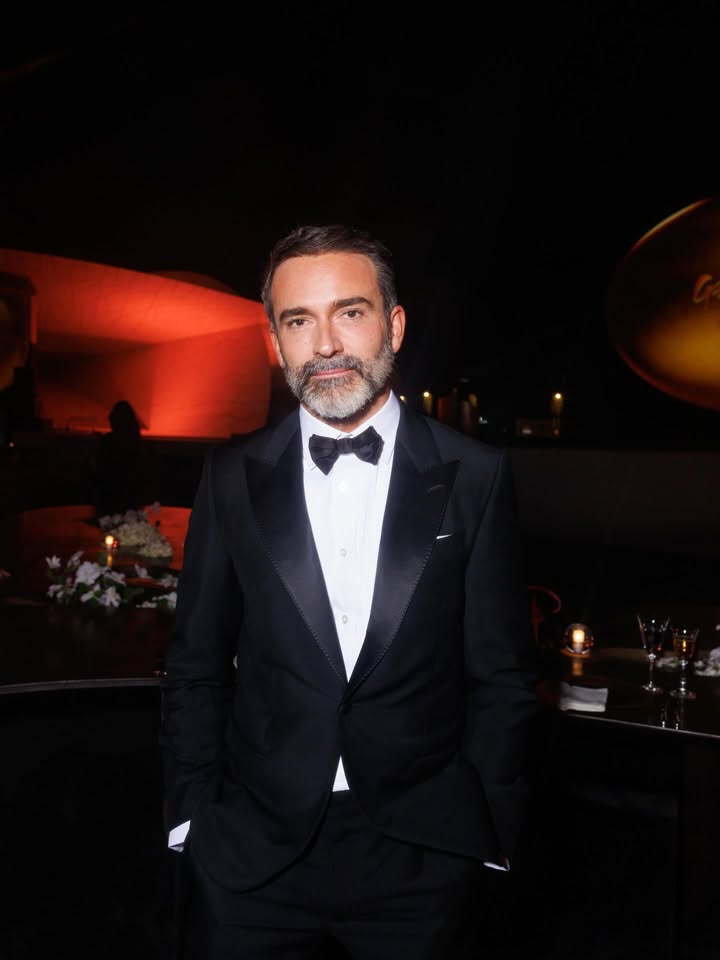 May be an image of one or more people, beard, suit, dinner jacket, bowtie, blazer and text