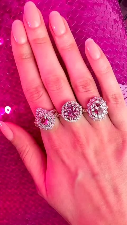 Pink scalloped rings that look like flowers with pink tourmaline, pink sapphire, and diamonds.