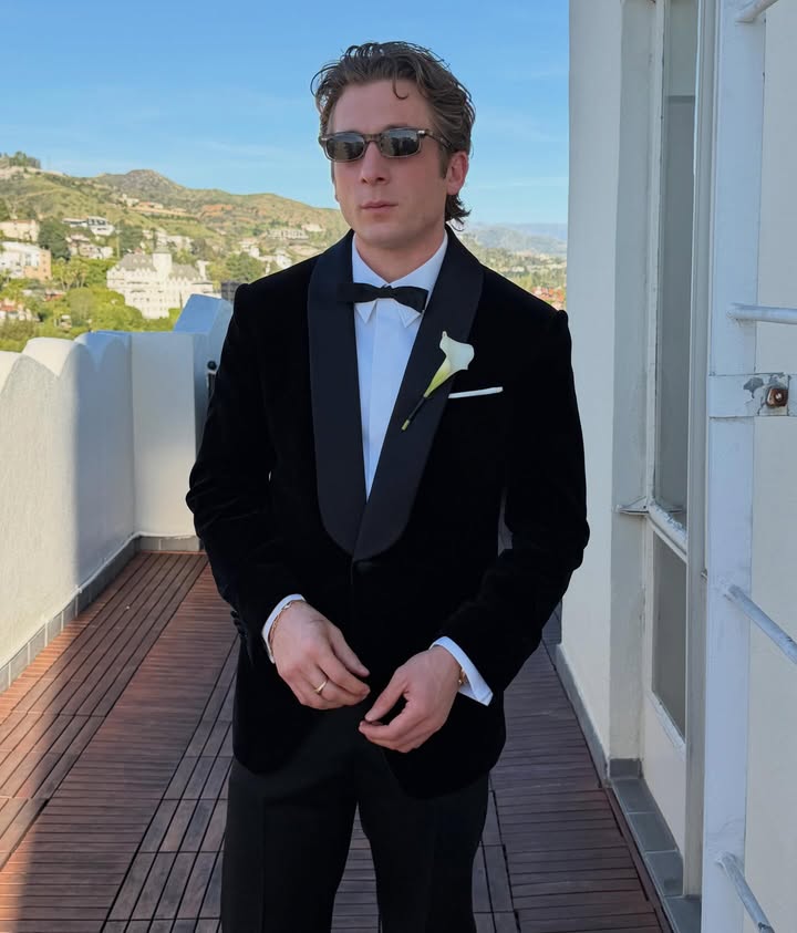 May be an image of suit, dinner jacket and text