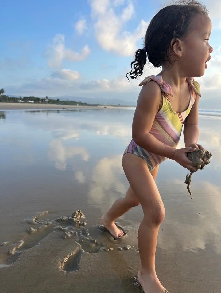 May be an image of baby, ocean, beach and text