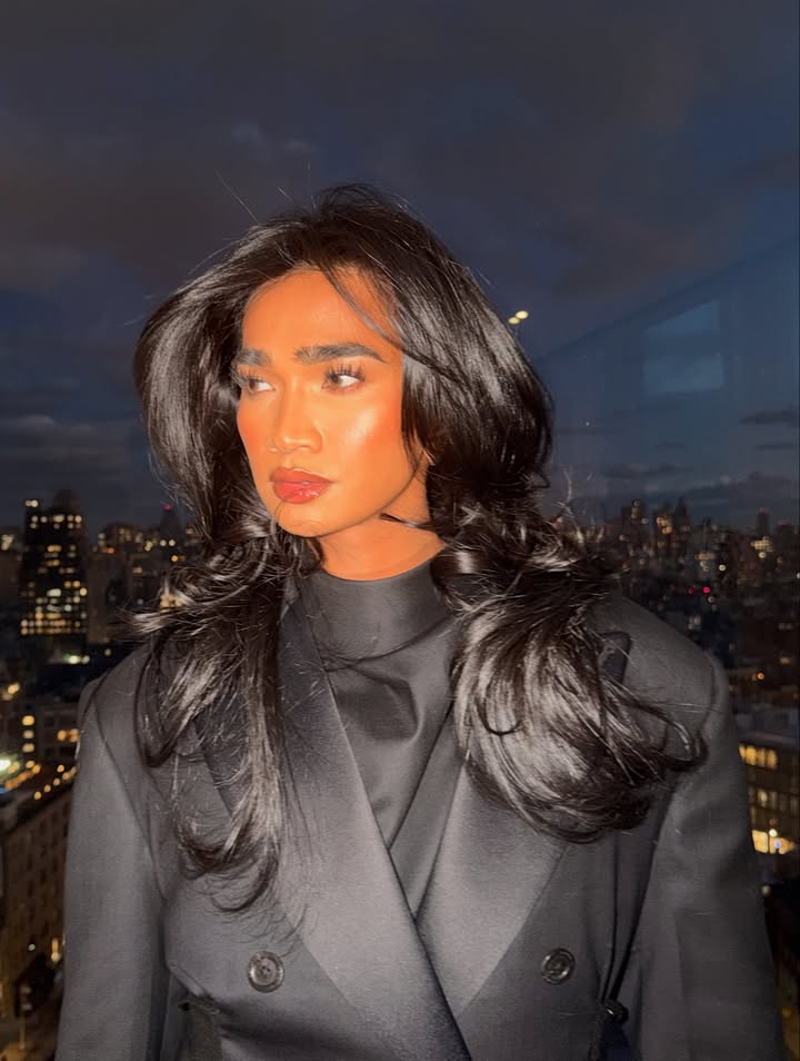 May be an image of one or more people, makeup, hair, overcoat, suit, blazer, mannequin and text