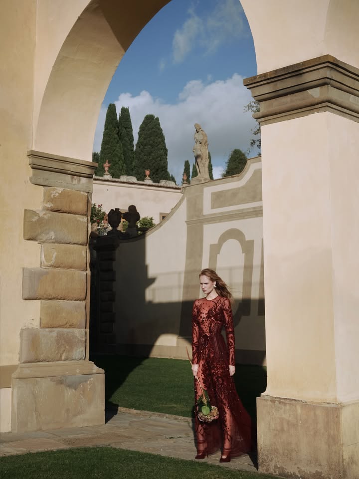 May be an image of gown and text