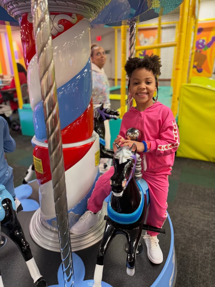 May be an image of child, pony, carousel and text