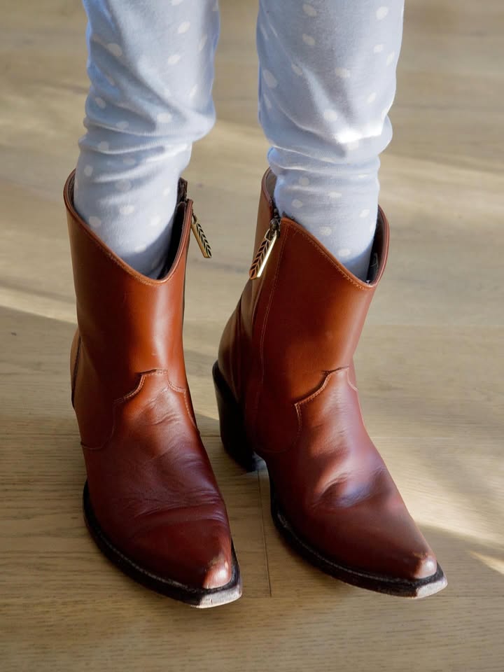 May be an image of wingtip shoes, leather, boots and text