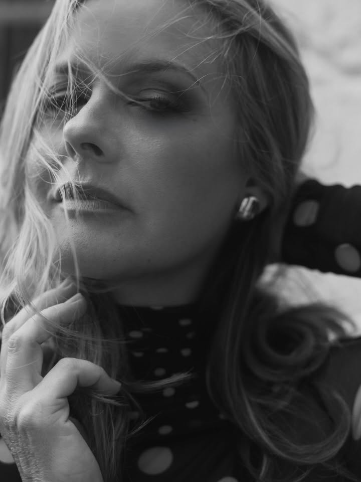 May be a black-and-white image of one or more people, blonde hair, makeup, turtleneck and text