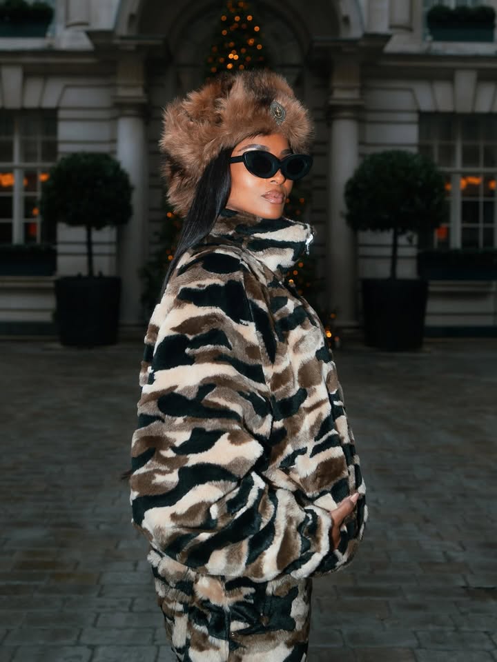 May be an image of overcoat, eyewear, fur coat, military uniform, jacket, beret, parka and text