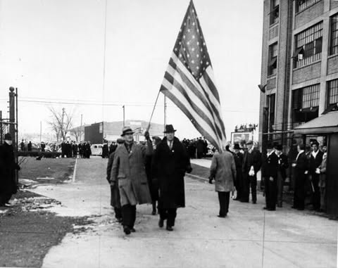 May be an image of standing, flag and text