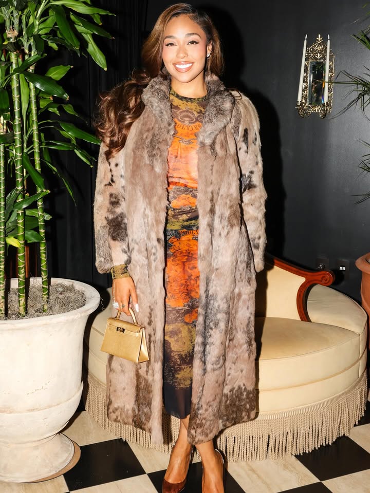 May be an image of sable coat and text