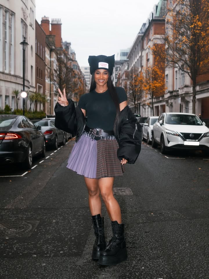 May be an image of boots, bowler hat, outerwear, turtleneck, kilt, miniskirt, headscarf, beret and text