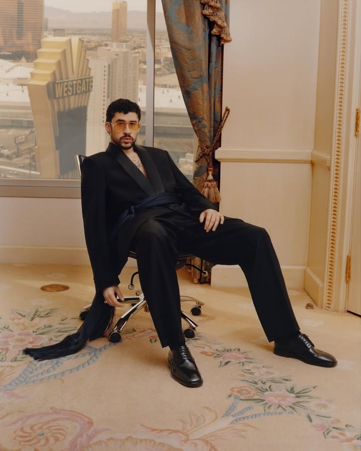 May be an image of overcoat, turtleneck, dinner jacket, magazine, blazer, suit and text