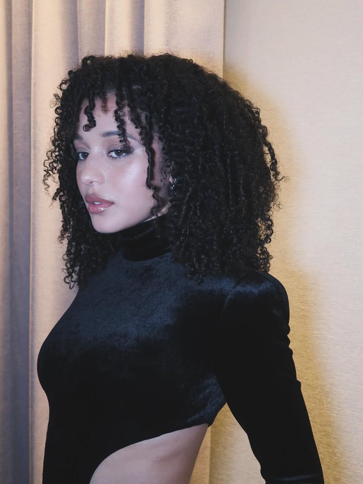 May be an image of one or more people, makeup, long hair, turtleneck and text