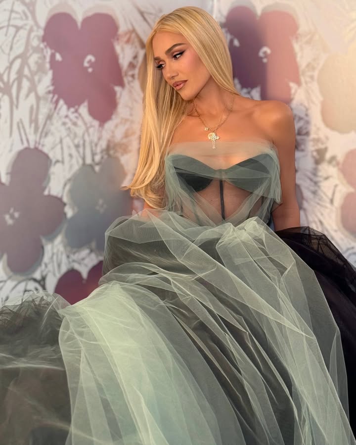 May be an image of one or more people, makeup, gown, dress and text