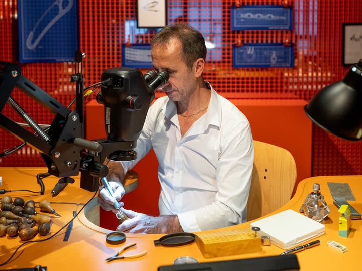 May be an image of wrist watch, drill press, microscope and text