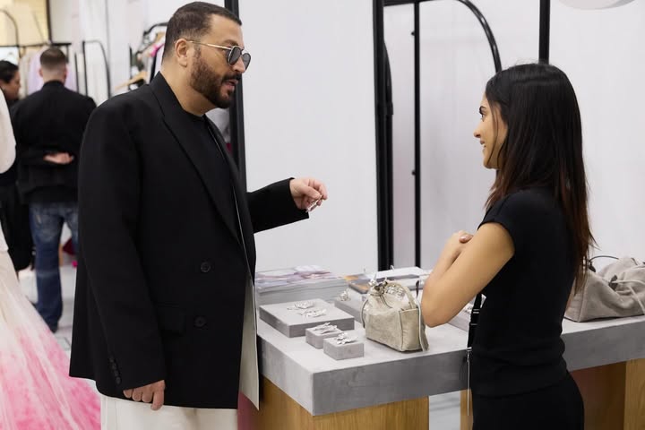 May be an image of suit, dinner jacket, gown and text