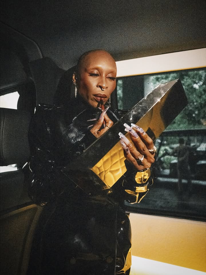 May be an image of one or more people, makeup, leather, clutch, magazine and text