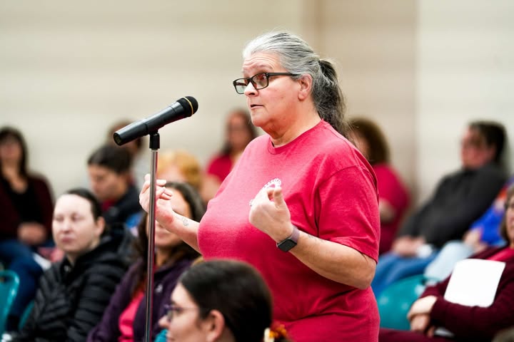 May be an image of one or more people, microphone and text