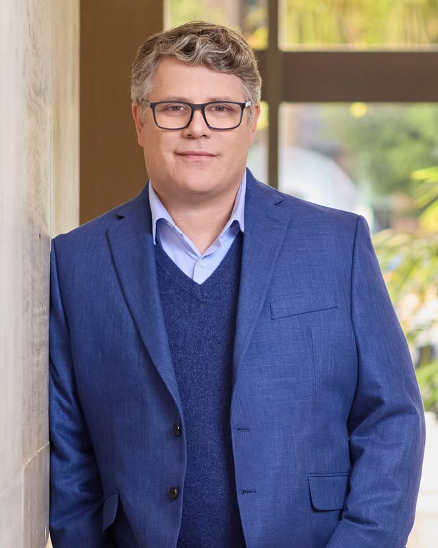 May be an image of one or more people, eyeglasses and text