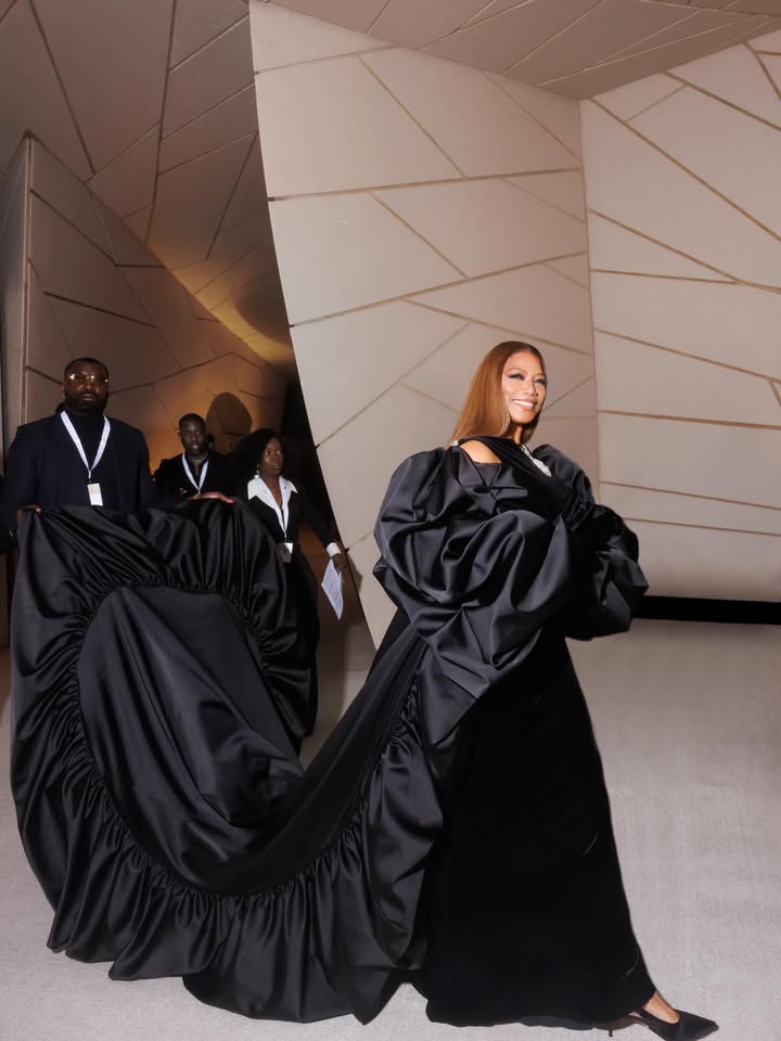 May be an image of gown and text