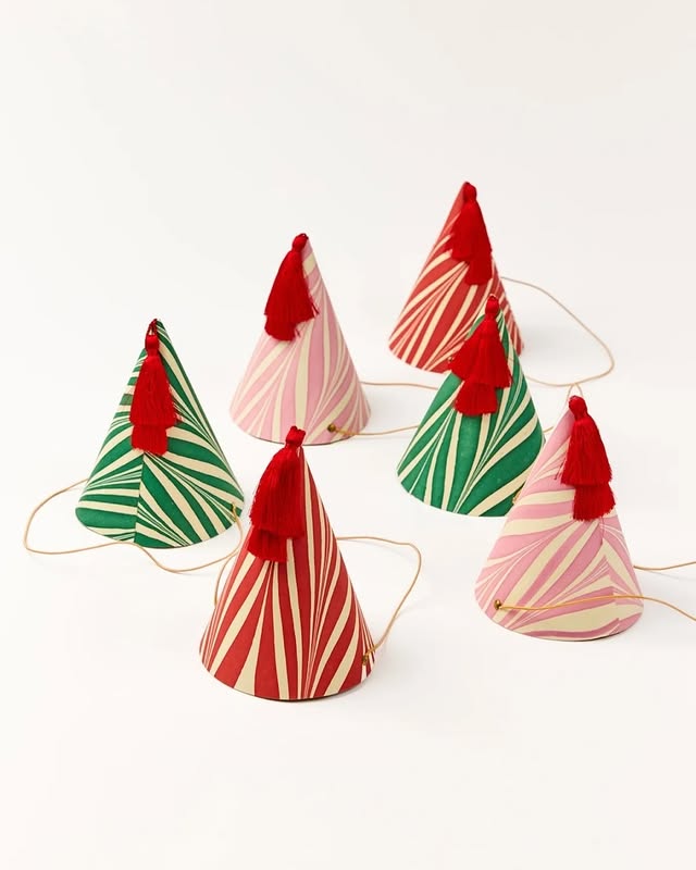 May be an image of napkin ring, christmas tree, icecream cone, tinsel and text