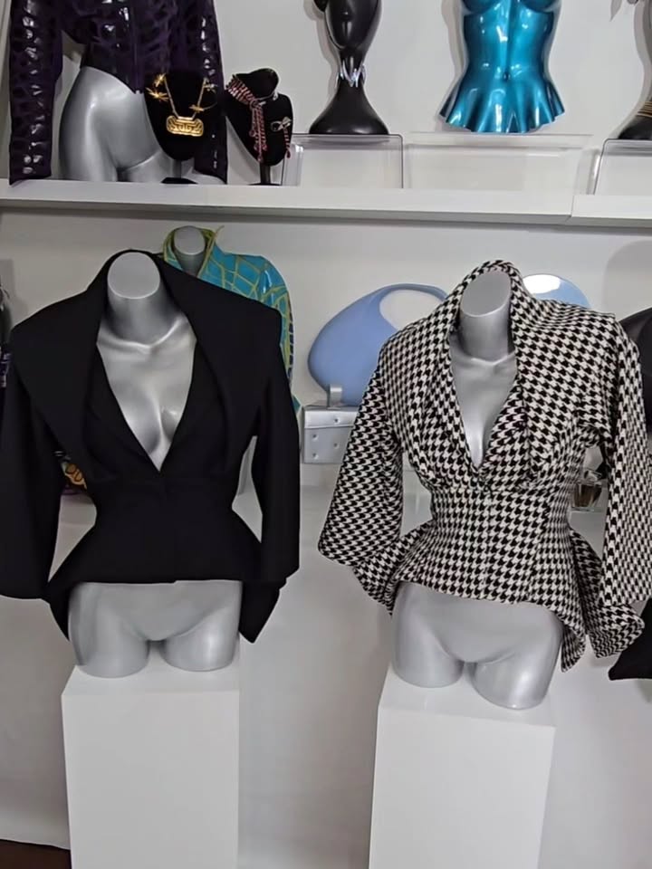 May be an image of mannequin, suit, display case, blazer and text