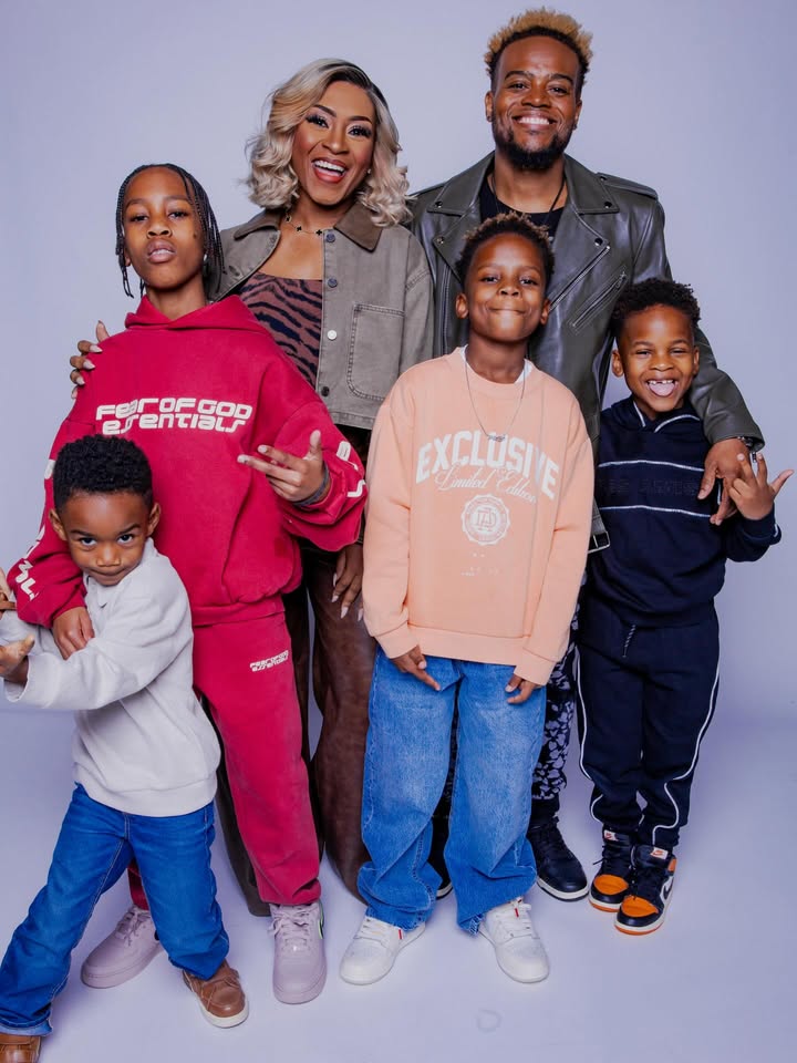 May be an image of baby, smiling, standing, sweatsuit, sweatshirt and text