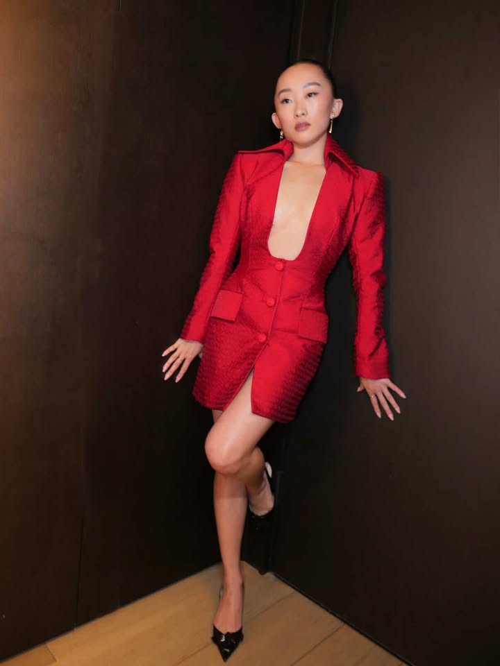 May be an image of suit, blazer and text