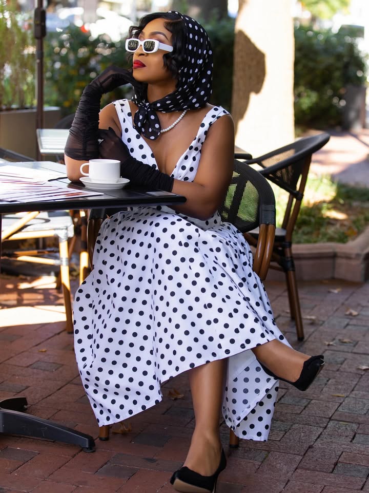 May be an image of headscarf, beret, dress, parasol and text