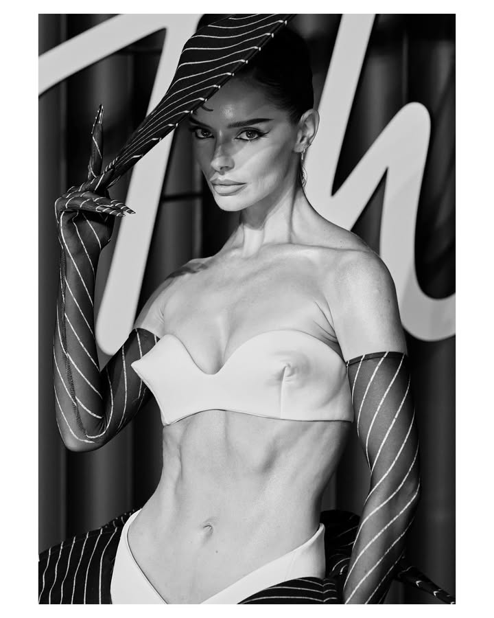 May be a black-and-white image of one or more people, makeup, fishnet stockings, bra and text