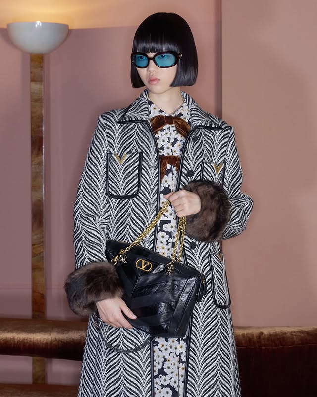 May be an image of duffle coat, sable coat, overcoat and text