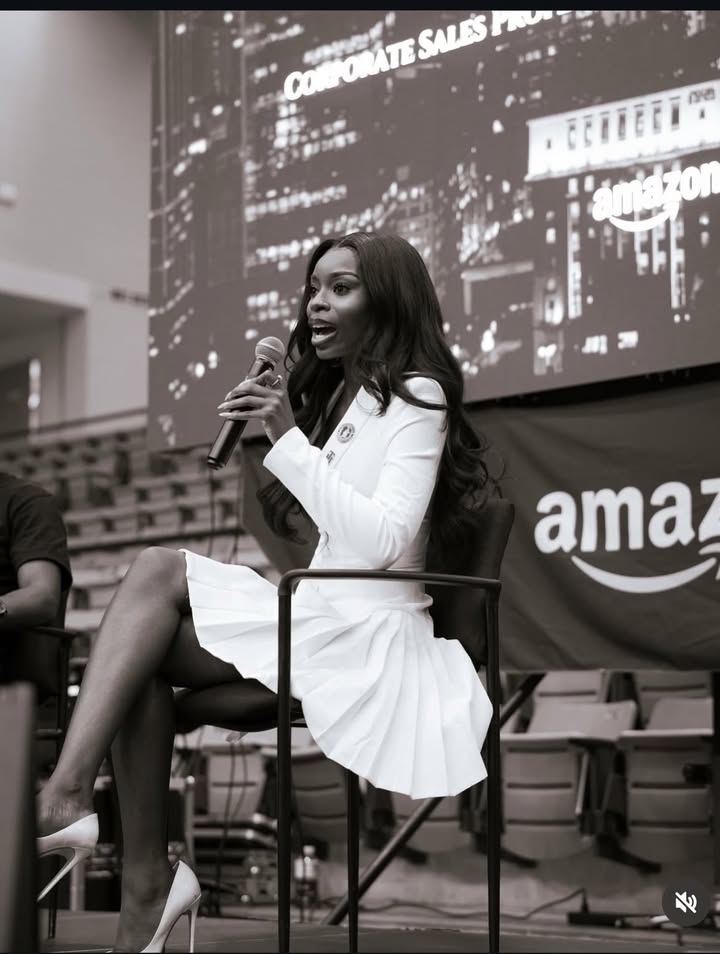 May be an image of one or more people, microphone, suit and text