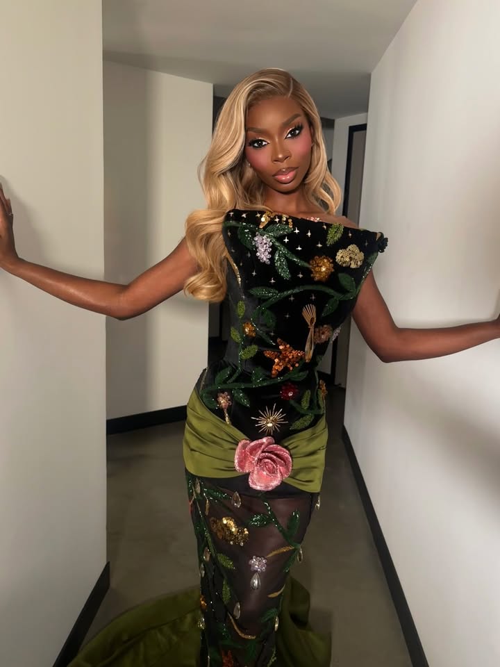 May be an image of one or more people, makeup, gown, dress and text