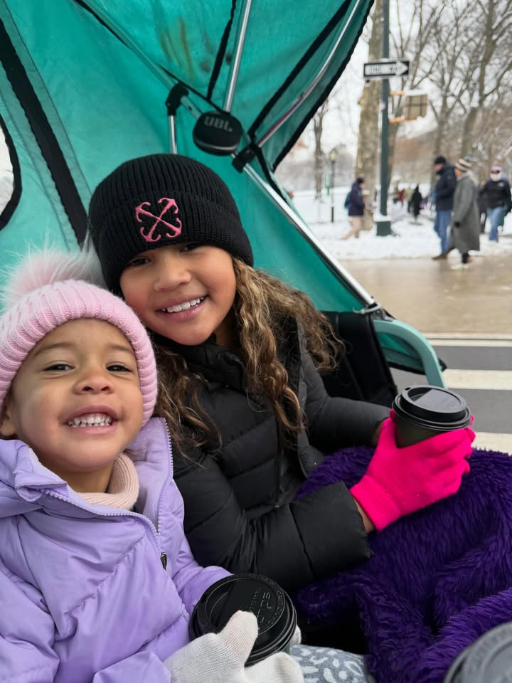 May be an image of child, fleece, snowsuit, carriage, park, snow and text