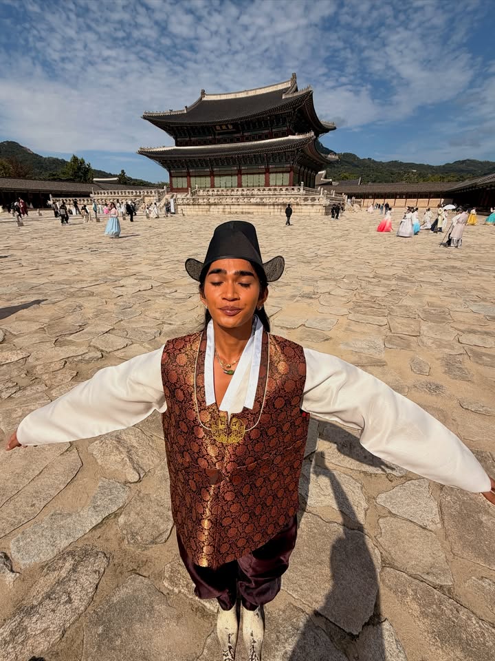 May be an image of sarong and Gyeongbokgung Palace