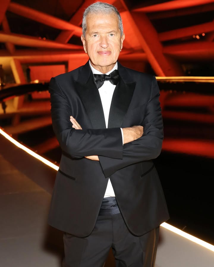 May be an image of one or more people, suit, dinner jacket and text