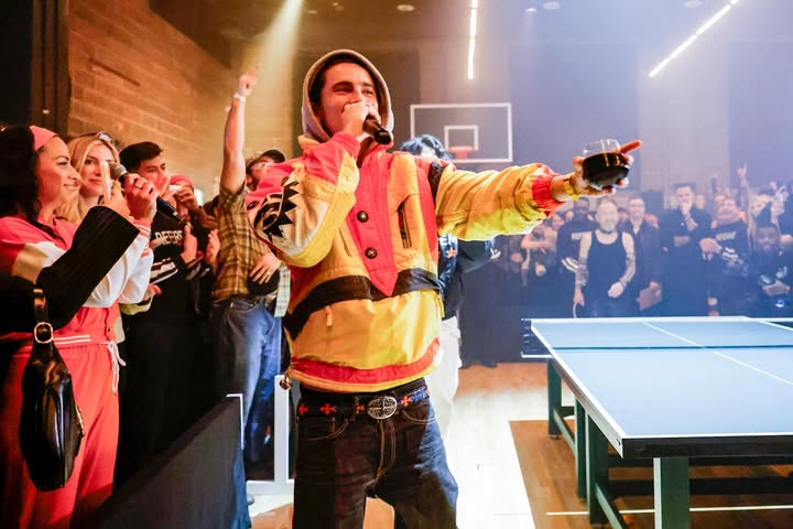 May be an image of racket, crowd and text