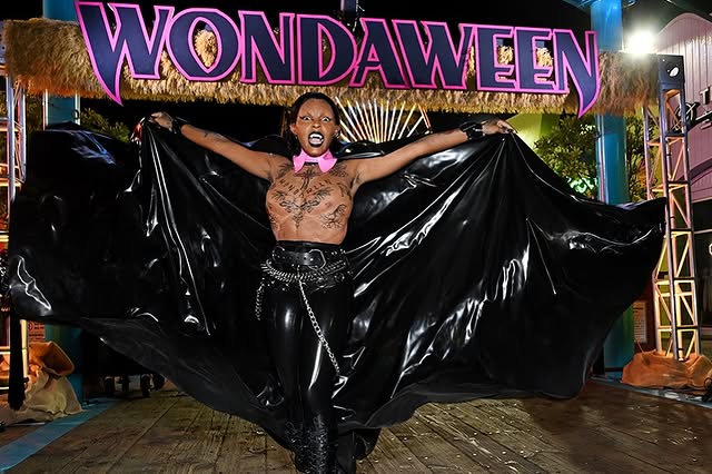 May be an image of one or more people, makeup, costume, cloak and magazine