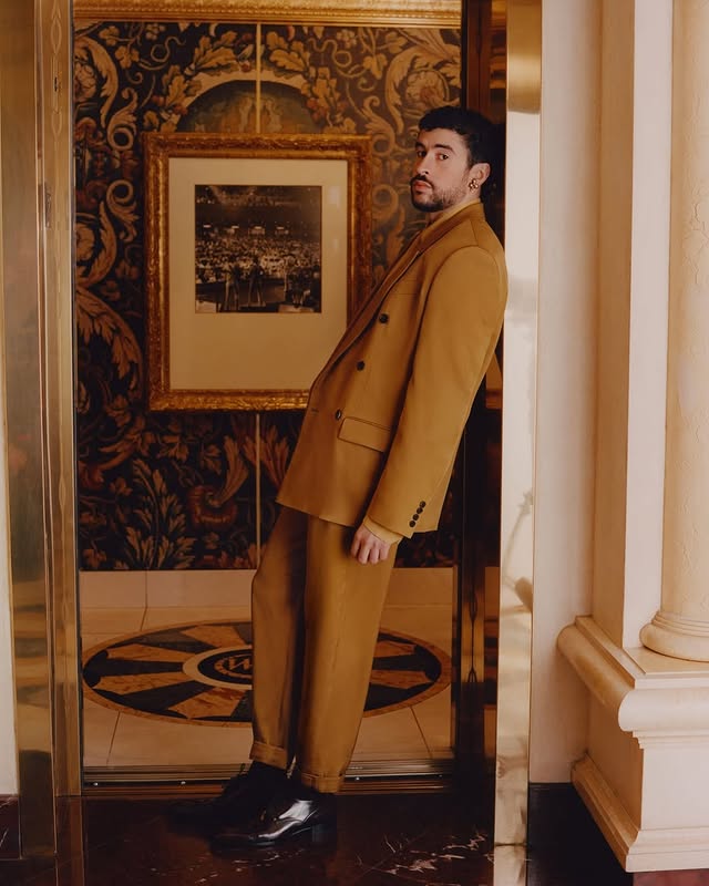 May be an image of suit, overcoat, blazer, dinner jacket, turtleneck and text