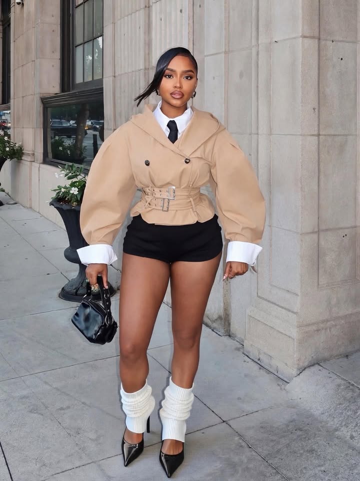 May be an image of overcoat, blazer, turtleneck, miniskirt and text