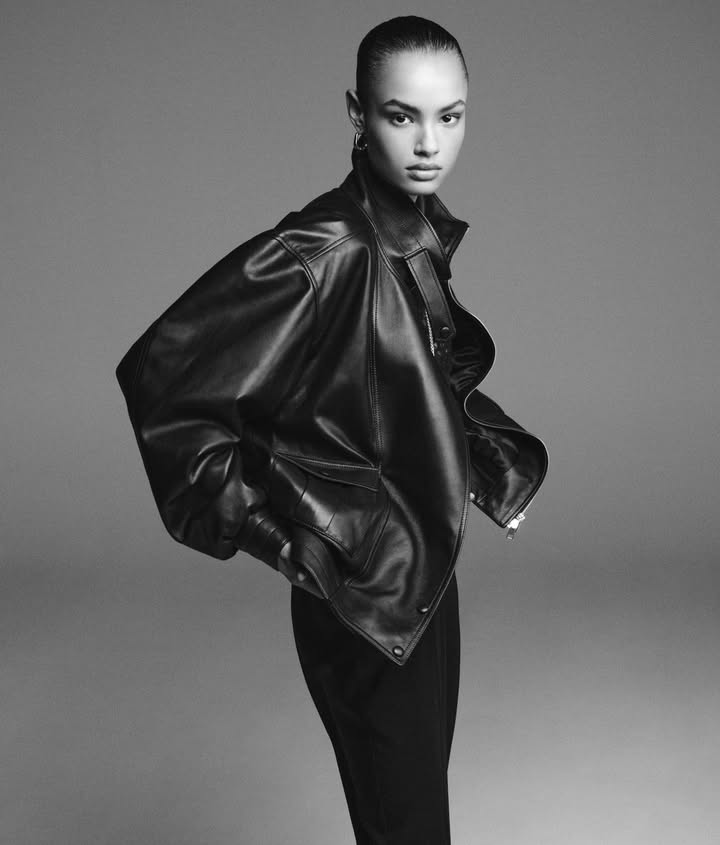 May be a black-and-white image of one or more people, makeup, leather, jacket, coat and text