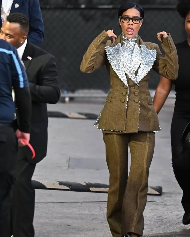 May be an image of one or more people, coat, blazer and text