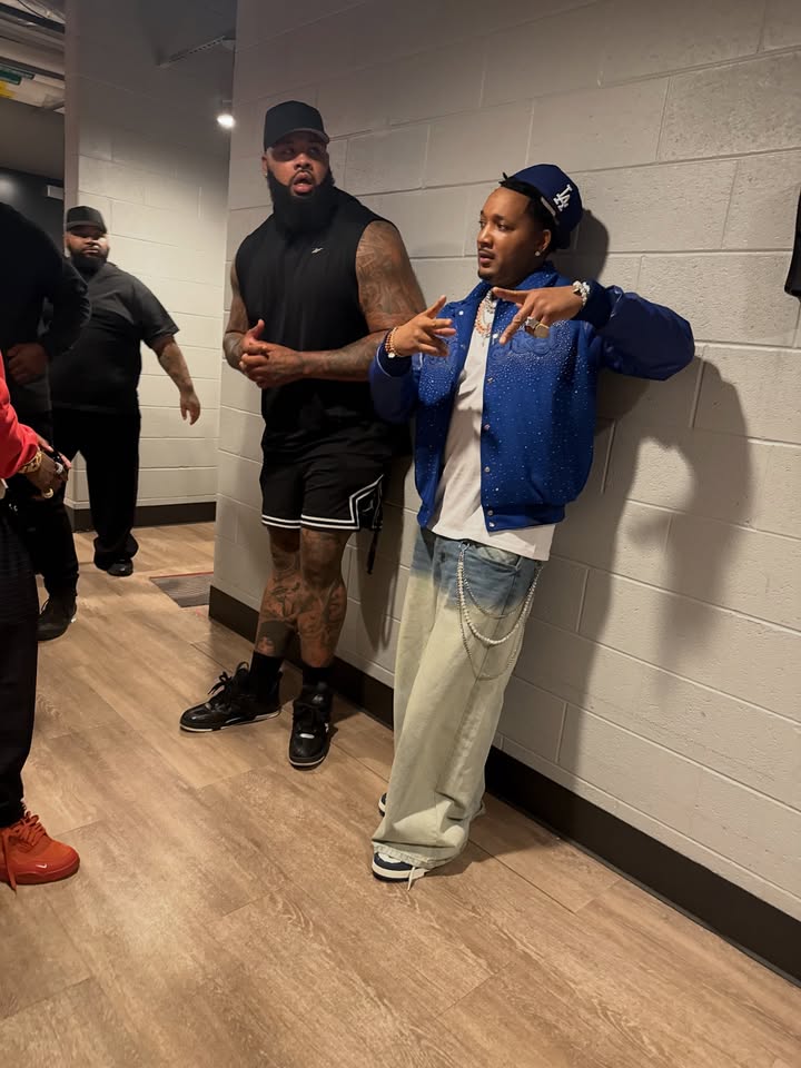 May be an image of one or more people, people standing, sweatsuit and text