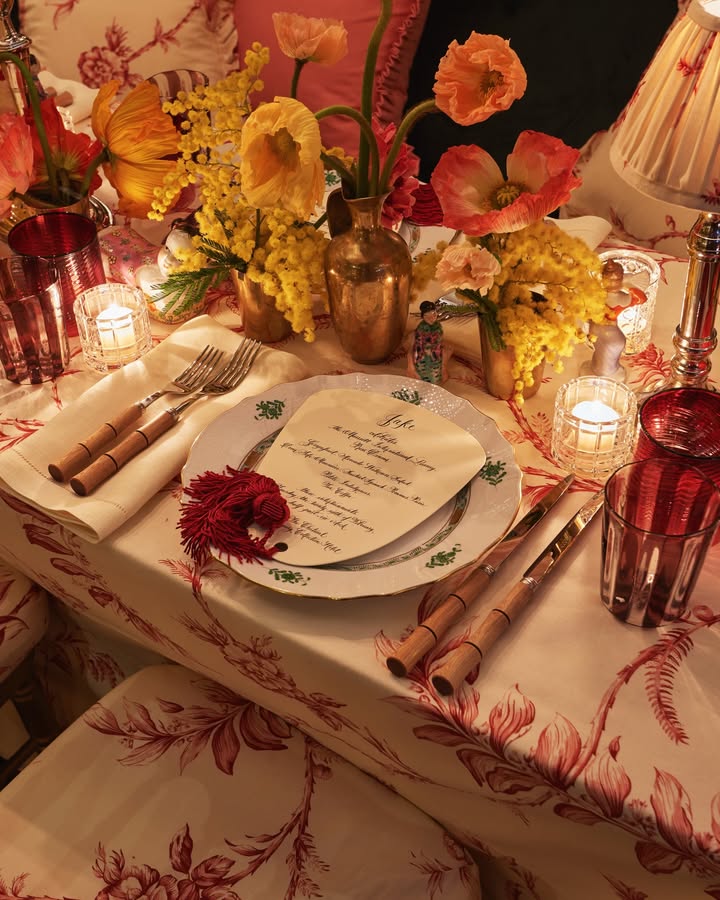 May be an image of napkin ring, candle holder, flower arrangement, chinaware, tablecloth, napkin and text