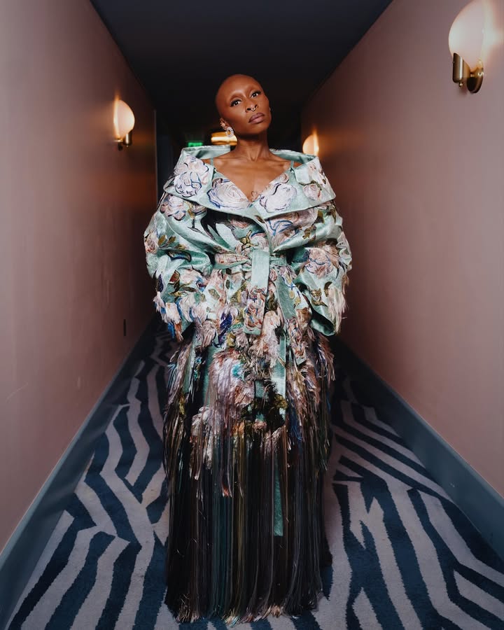 May be an image of one or more people, makeup, gown, turtleneck, dress and text