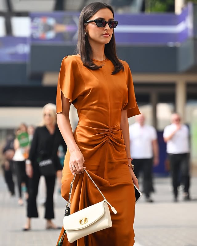 May be an image of dress and text