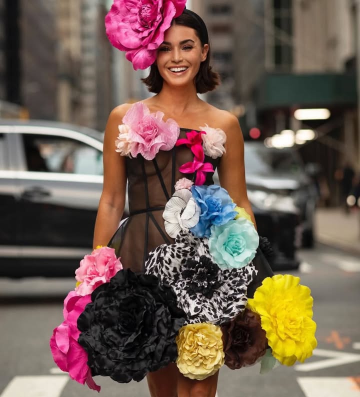 May be an image of dress, headdress and text