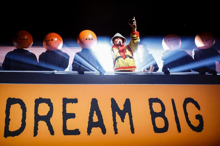 May be a cartoon of blimp, poster and text that says 'DREAM EAMBIG BIG'