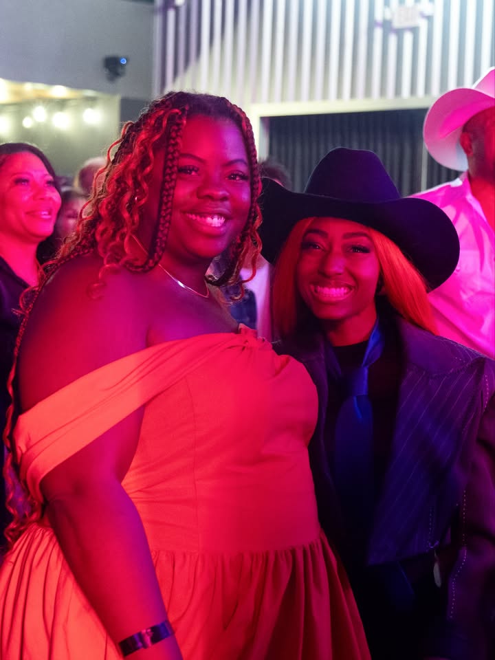 May be an image of one or more people, night and text