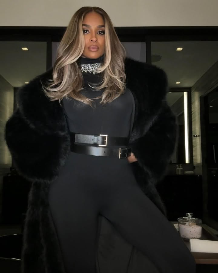 May be an image of one or more people, makeup, sable coat, belt, choker, turtleneck, jumpsuit and text