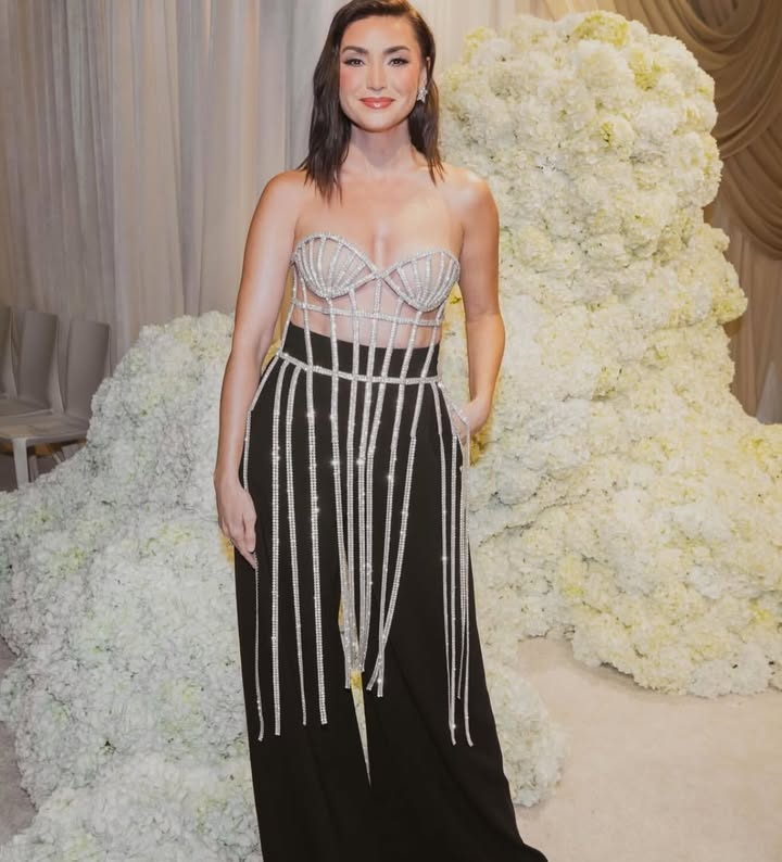 May be an image of one or more people, makeup, gown, dress and text